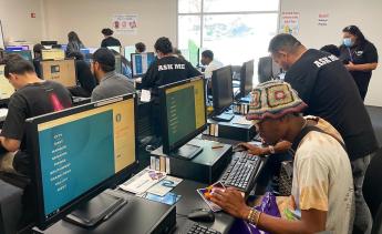 Students receiving help in computer lab