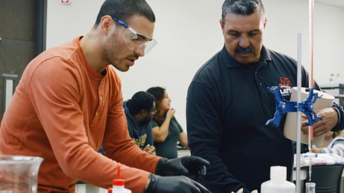 Professor teaching chemistry student